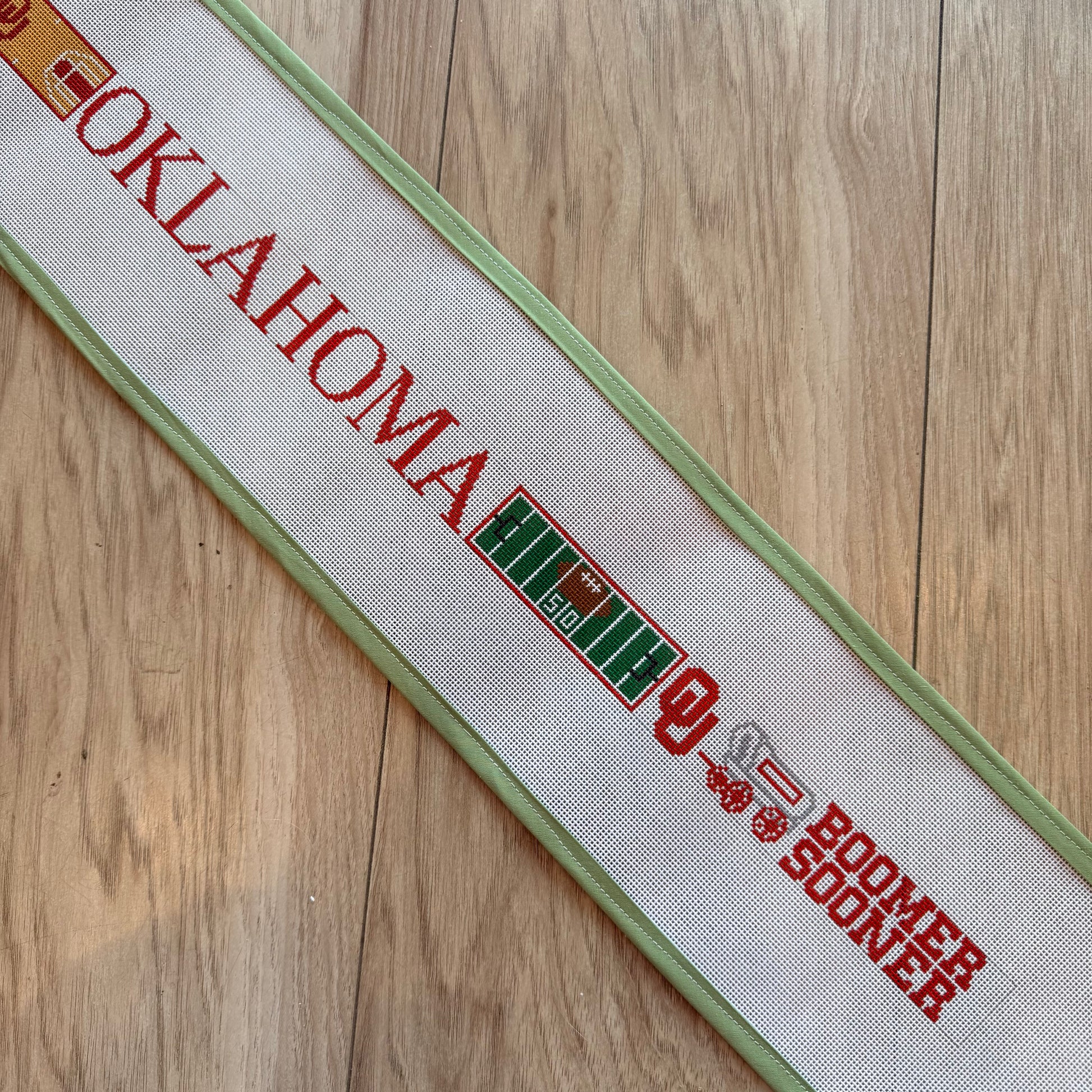 Oklahoma Field & Court-Small Version Belt needlepoint canvas by Elm Tree, 18 mesh 
31" x 1.5"